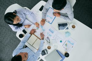 Business executives discussing charts and graphs at table