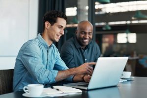 two guys looking at the pc